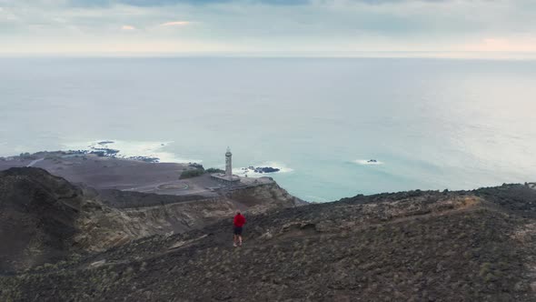 Man Jogging Down Mountain Path of Capelinhos Volcano Faial Island Azores alt