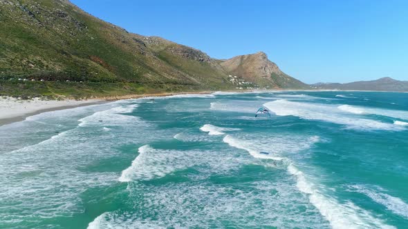 Drone Shot of a Kiteboarder Riding the Wind Out to Shore