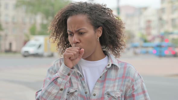 African Woman Coughing While Standing Outdoor alt