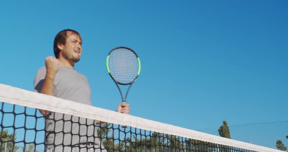 Male Athlete Playing Tennis on Outdoors Hard Court. Happy Man in Celebration of Success and Win. alt