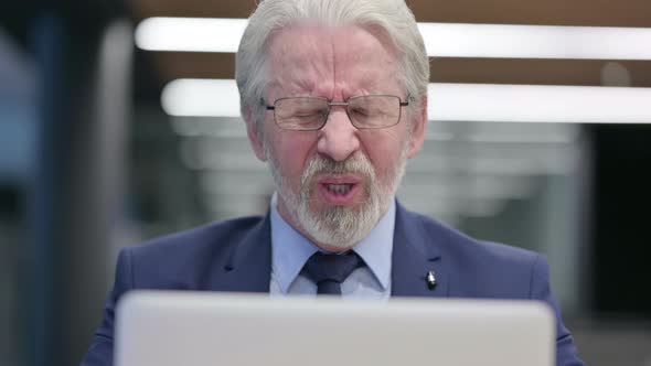 Close Up of Old Businessman with Laptop Having Headache alt