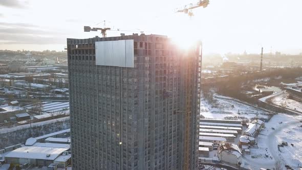 Take the Camera Up a Building Under Construction with Empty Ceilings in the Contrasting Light of the