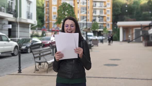 Young happy girl reads good news. alt