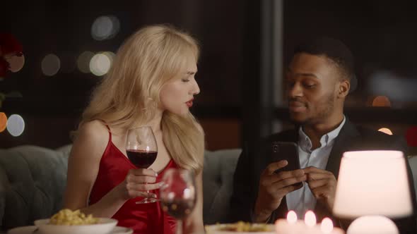 Wife Catching Husband On Infidelity While He Texting In Restaurant alt