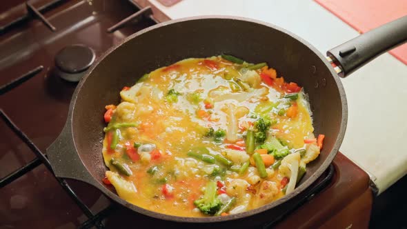 Vegetable Stew with Egg Boiling in a Frying Pan