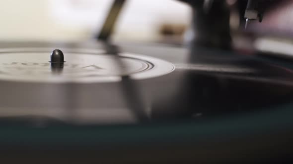 Placing a Record Player Needle on a spinning Vinyl Record Close up shot alt