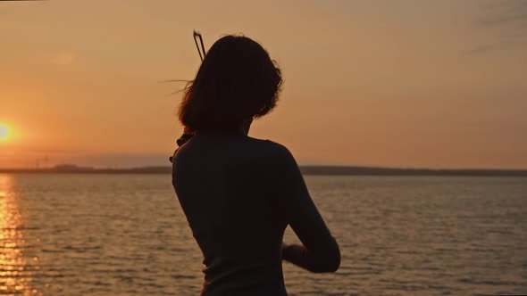 Silhouette of Lady Playing On Sunrise