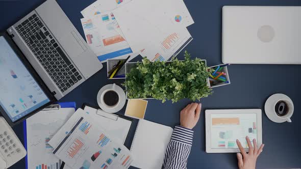 Top View of Businesswoman Analyzing Financial Graphs Statistics Drinking Coffee alt