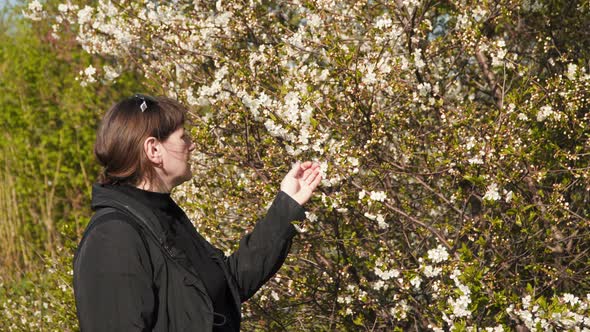 Young Woman Near a Flowering Tree