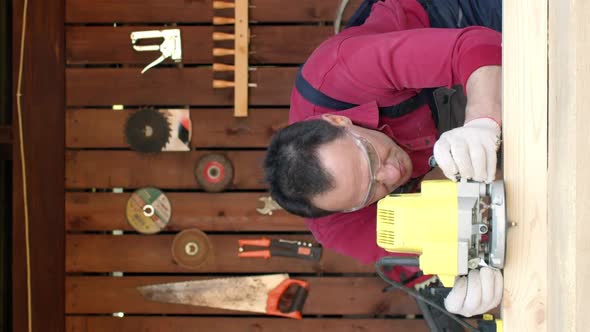 Vertical Shot Woodworker Processes Wood with a Milling Machine in His Carpentry Workshop