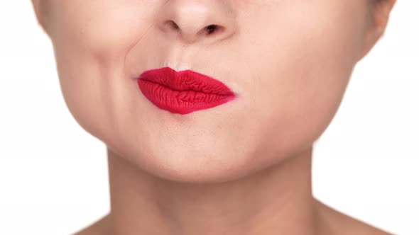 Extreme Close Up Portrait of Irritated Female Person Twisting Her Lips Covered with Red Matte alt