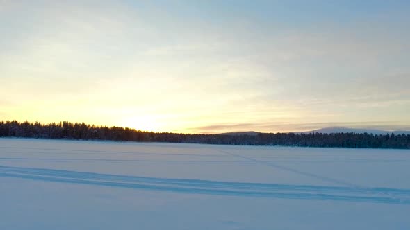 Aerial view of a winter landscape with forests and mountains at sunset in Gällivare, in northern Swe alt