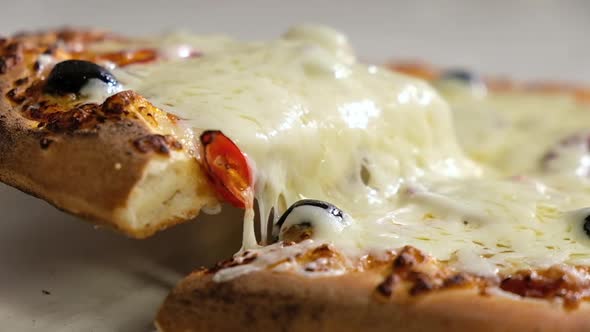 People man picks up sliced slice of pizza with melted cheese. Fast food close-up