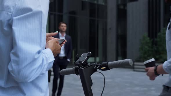 Closeup Hands Rent Electric Scooter Holding Smartphone alt