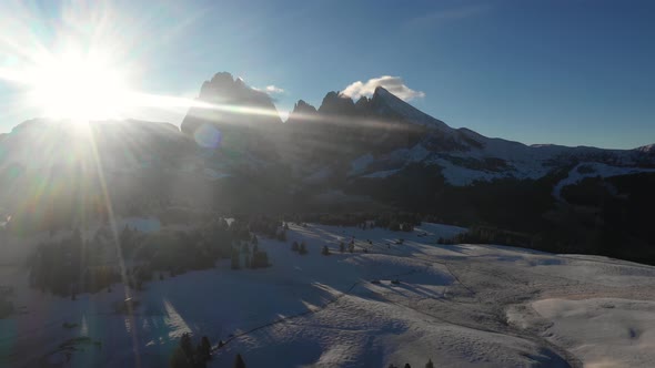 Aerial view of mountains with snow at sunrise - Backlight panoramic video of