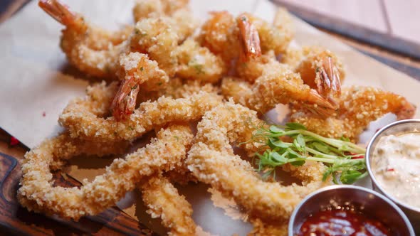 Tasty shrimps in breading cooked in deep fryer oven for beer snack in bar alt