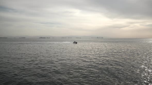 jet ski passing over the sea horizon	 alt