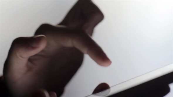 Person's hands using a tablet