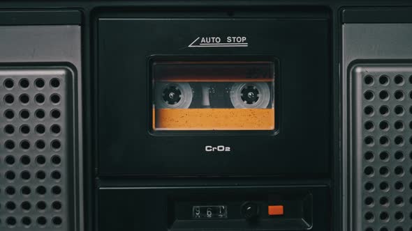 Vintage Yellow Audio Cassette Playing in Deck of an Old Tape Recorder alt