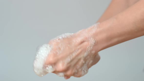Close-up of a girl soaping her hands with soap before washing