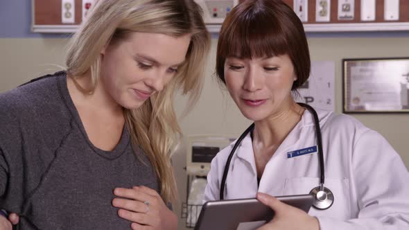 Doctor and patient look at digital tablet together