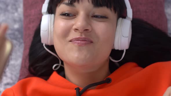 Beautiful brunette girl is dancing at home alt