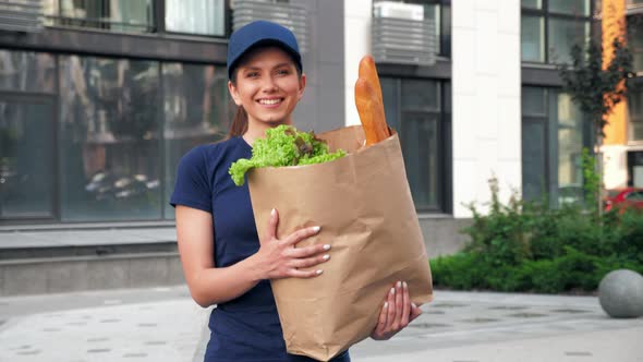 Smiling Delivery Woman Courier with Paper Bag Groceries to Deliver Order Client alt
