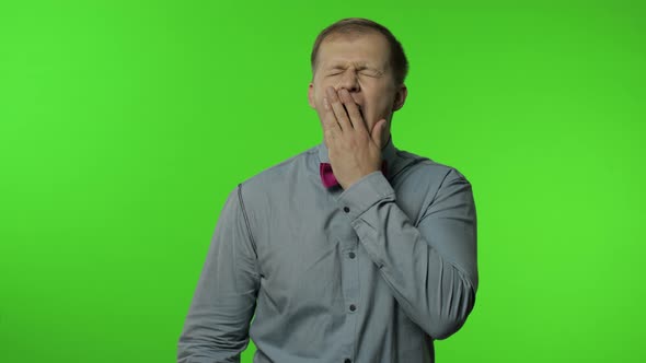 Tired Man Yawning and Stretching Hands, Waking Up, Dreaming of Rest, Feeling Lazy Drowsy, Insomnia alt