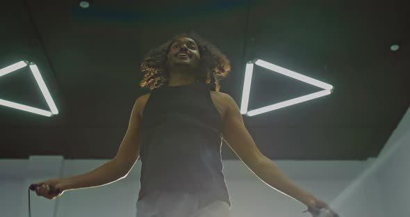 Black Man is Skipping Rope Training in Gym Tilt Up View on African Sportsman  Prores alt