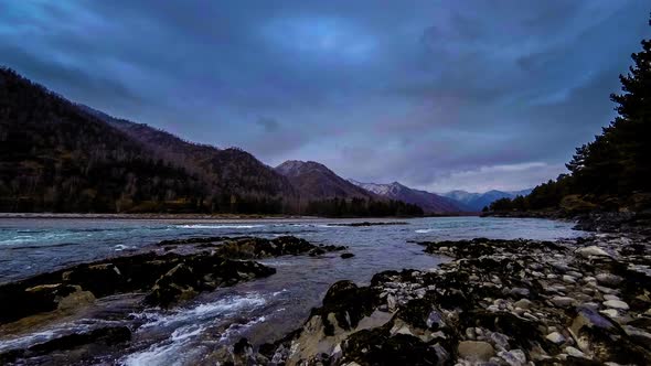 Time Lapse Shot of a River Near Mountain Forest. Huge Rocks and Fast Clouds Movenings. alt