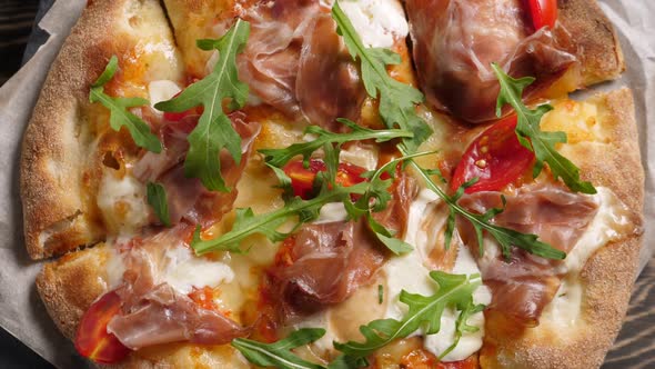 Prosciutto Pizza with Strachatella Cheese Tomatoes and Arugula Leaves alt