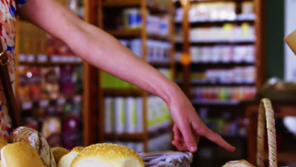 Male staff packing bread in paper bag alt