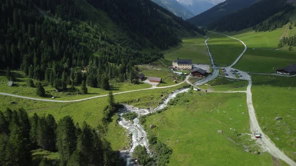 Drone aerial view from Lüsens valley with the old Lüsens Inn and the high mountains of Austria in th alt