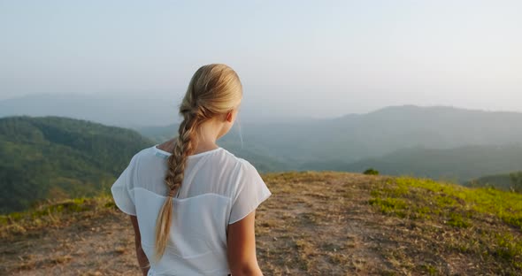 Rear View of Young Woman Walking in Mountain and Hag Herself