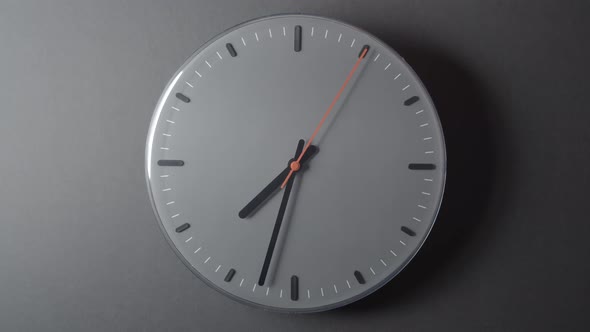 Clock Face in Time lapse full day on dark grey wall