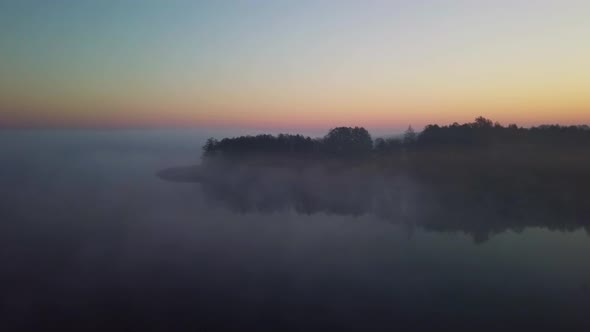 Aerial View Of Fog Mist Over Morning Lake