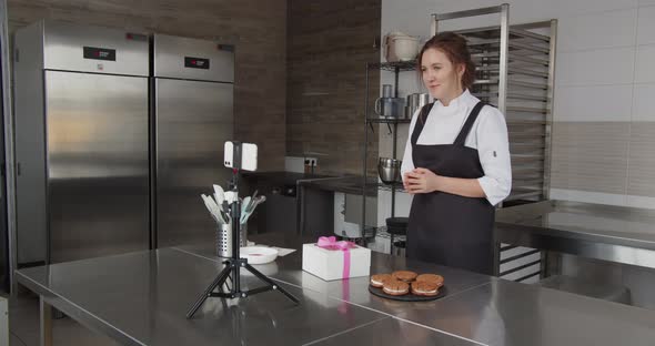 A Professional Chef Conducts a Master Class and Flips Through the Touch Screen alt