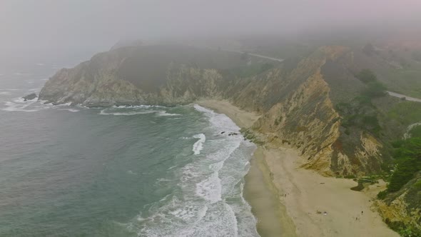 Drone Fly over Cliffs and sand seashore with blue water alt