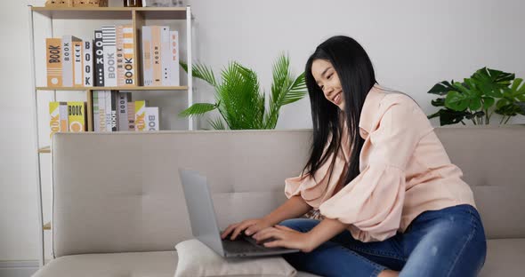 Woman  chatting and sitting on couch alt