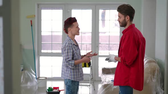 Side View Positive Woman and Man Talking Standing in House Under Repair alt