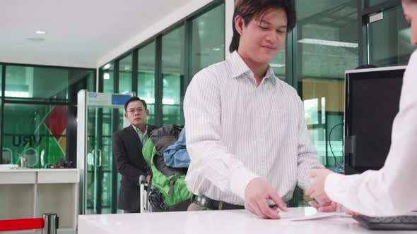 the confident man take check-in at the check-in counter at airport