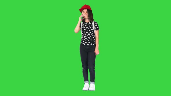 Young Asian Girl Talking on Smart Phone on a Green Screen Chroma Key alt