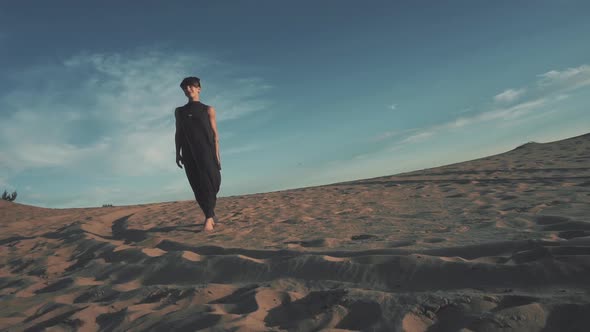 Young Beautiful Woman Walking in Desert Landscape