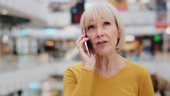 Mature Woman Talking on Cellphone Caucasian Serious Female Teacher Discussing Using Smartphone alt