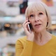 Mature Woman Talking on Cellphone Caucasian Serious Female Teacher Discussing Using Smartphone - VideoHive Item for Sale