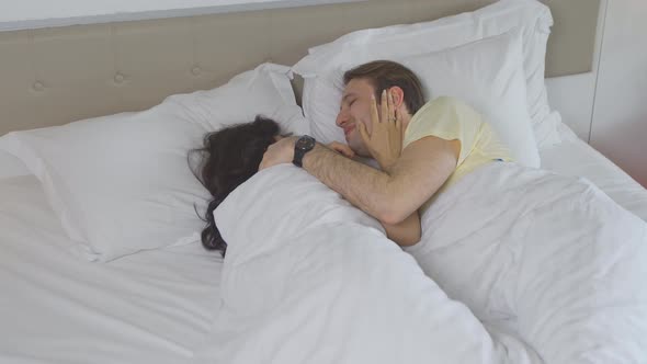 Couple waking up from sleep. alt