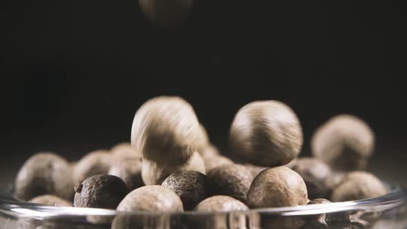 Slow Motion Pepper Falling Into a Bowl Close Up