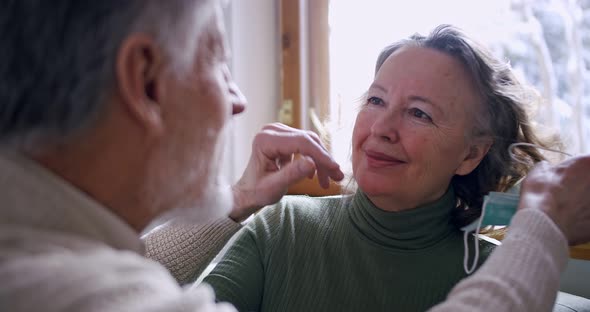 A Couple of Pensioners an Elderly Husband Removes the Protective Mask From His Wife and Kisses on