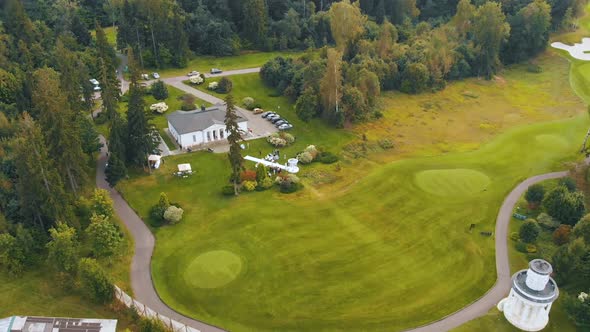Wedding Venue with Building Near Outdoor Stage White Chairs alt