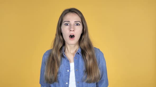 Surprised Pretty Woman in Shock Isolated on Yellow Background Wondering alt
